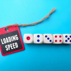 Dice and wooden board with the word LOADING SPEED.
