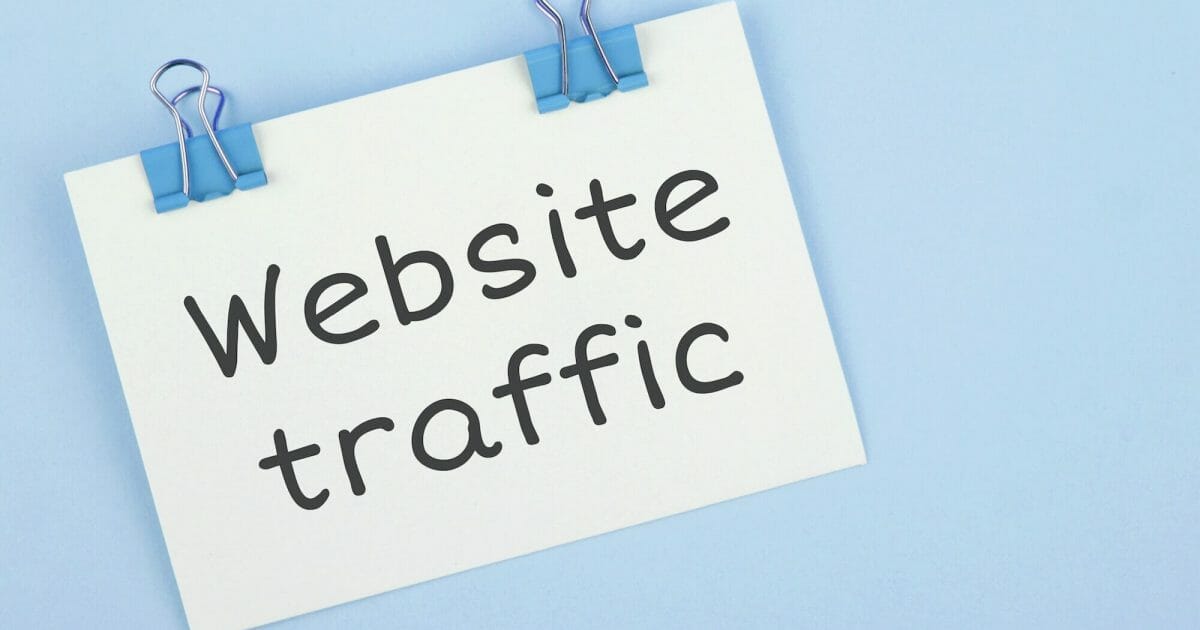 Inscription Website traffic. Note written on a white sticker with paper clip.