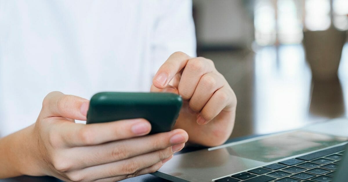 Close up of man using mobile phone.