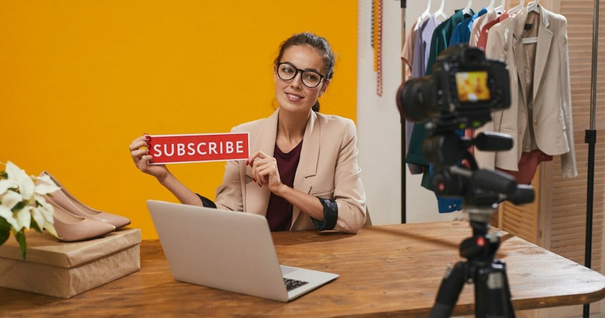 Fashio Blogger Holding Subscribe Button