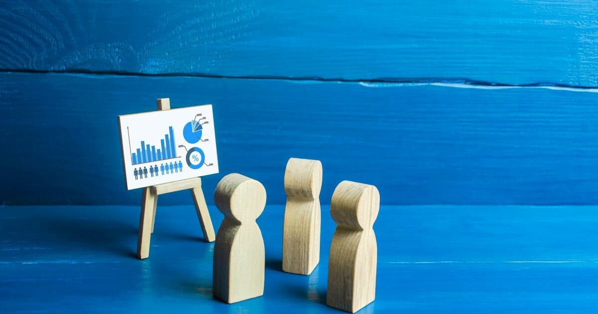 People examine the easel with calculations. Briefing and work meetup. Statistics information data