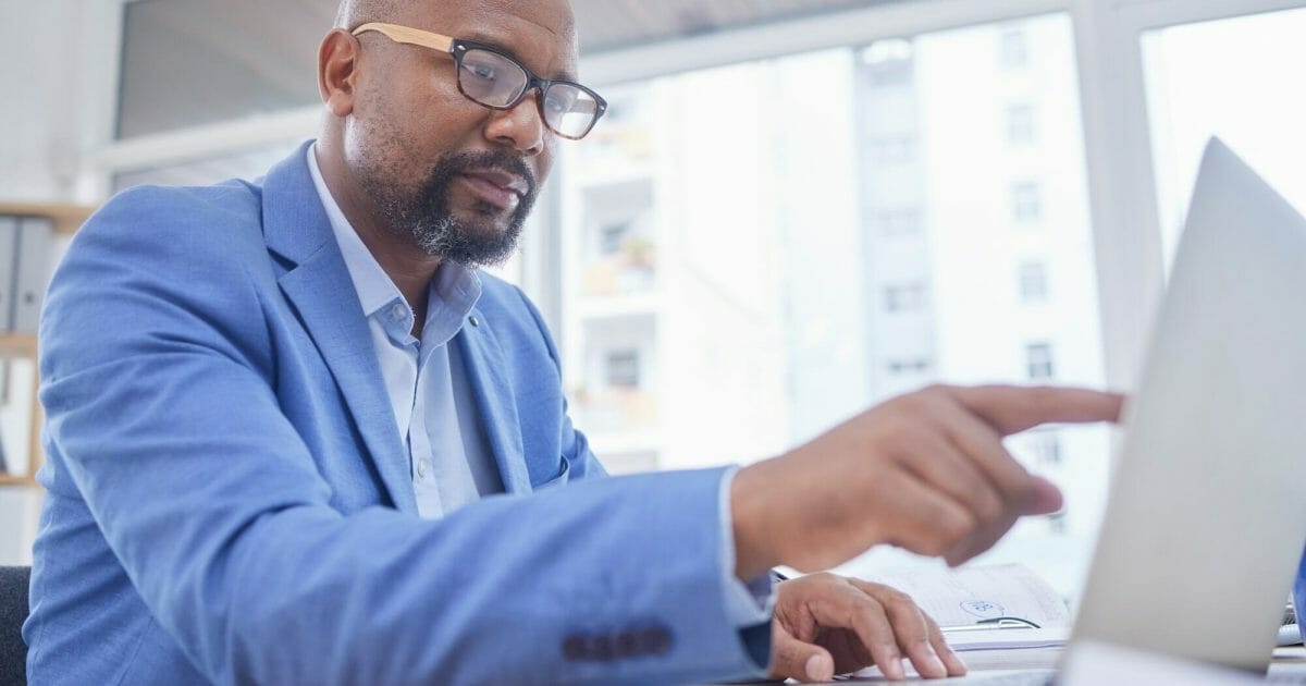 Thinking, black man point and business computer of an accounting website developer with idea. Lapto