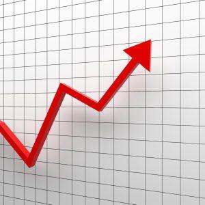 Growth diagram with red arrow going up on white background in success business concept